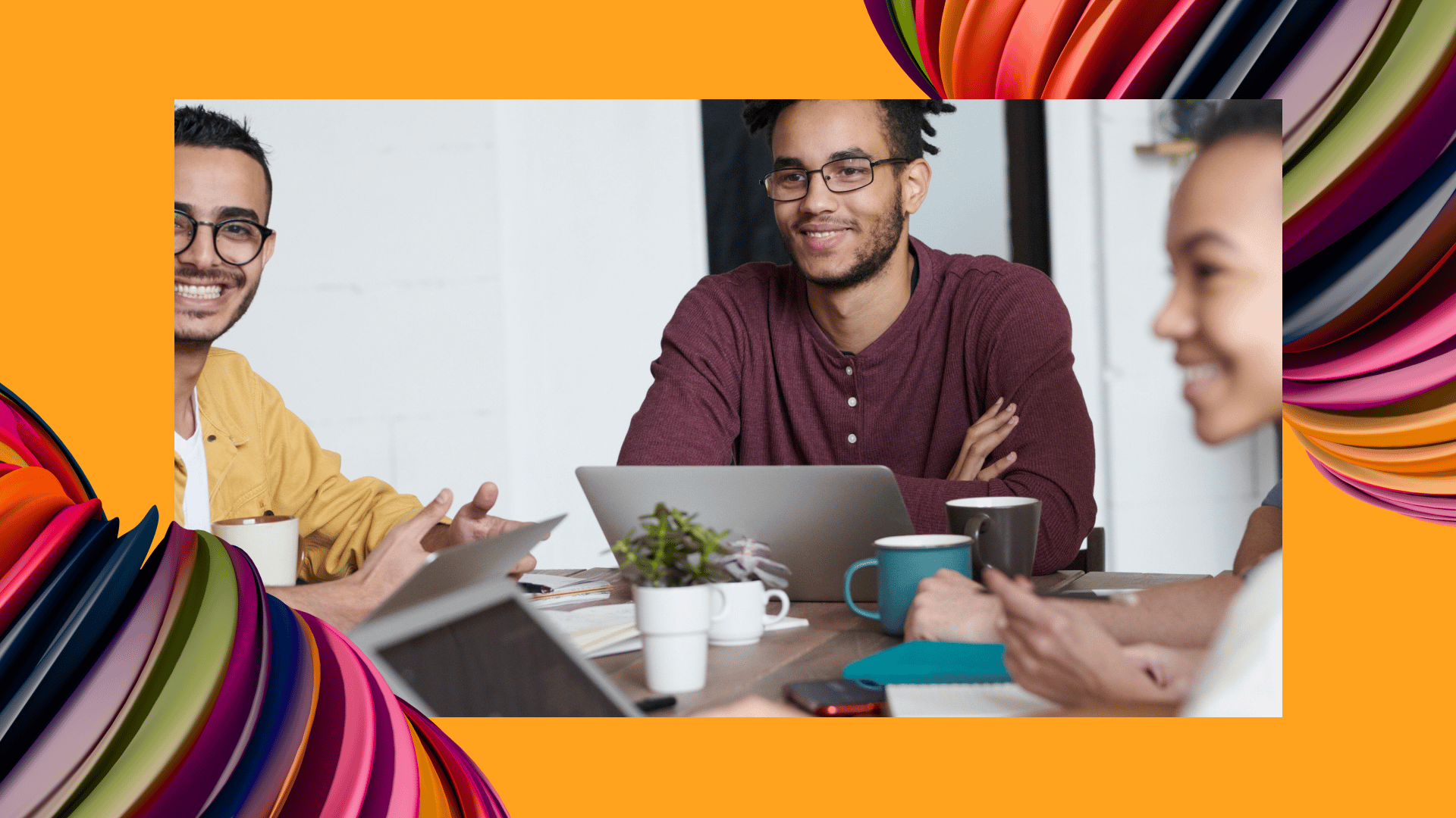 A group of smiling HR employees sit at a table and chat about the extended workforce.