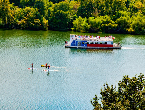 Cruise ship on a sunny river carrying a contingent workforce management event