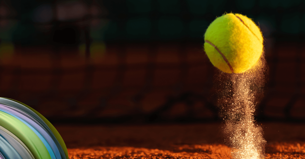 A yellow tennis ball bounces off the ground, suggesting a game is being played. 