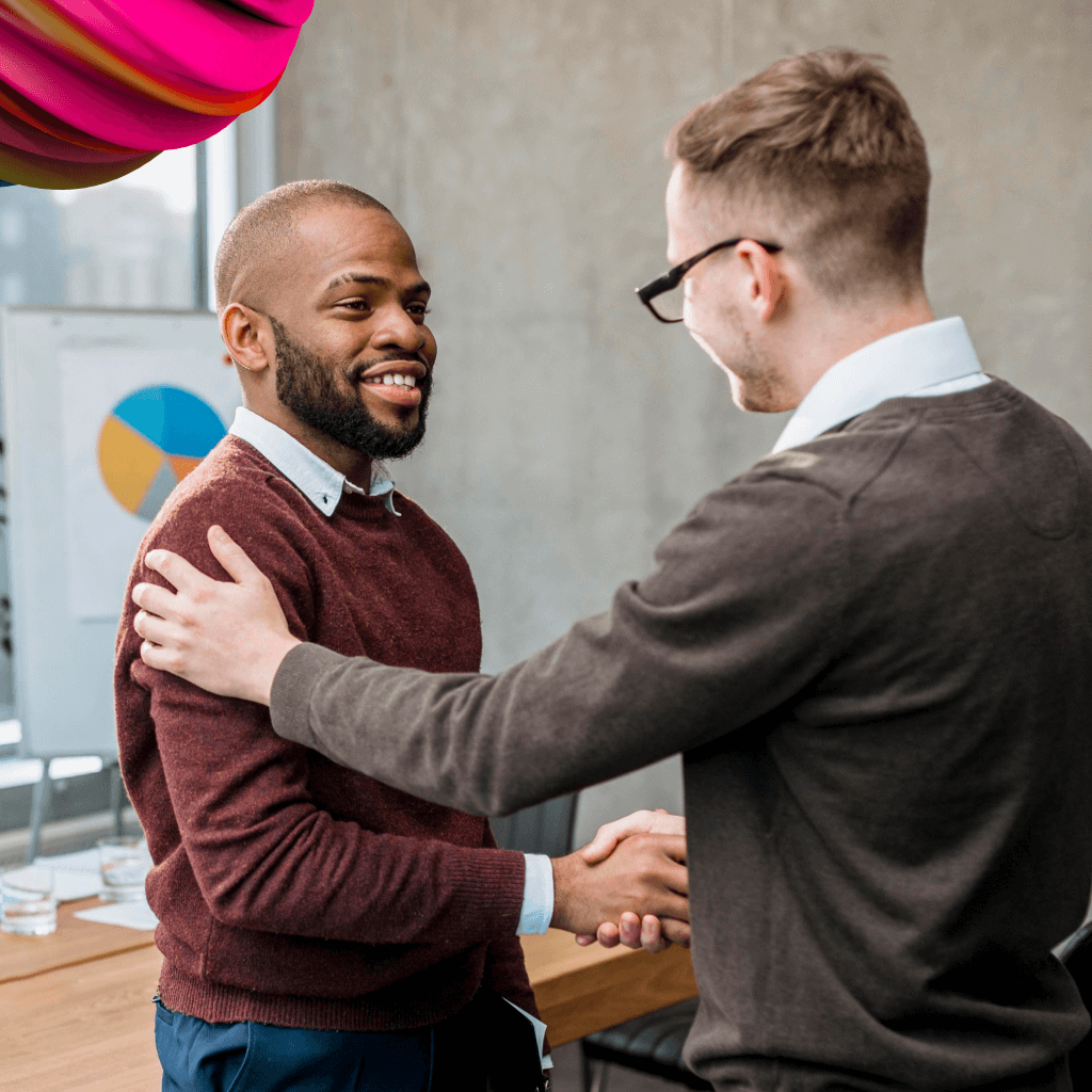 Two independent contractors are shaking hands and smiling