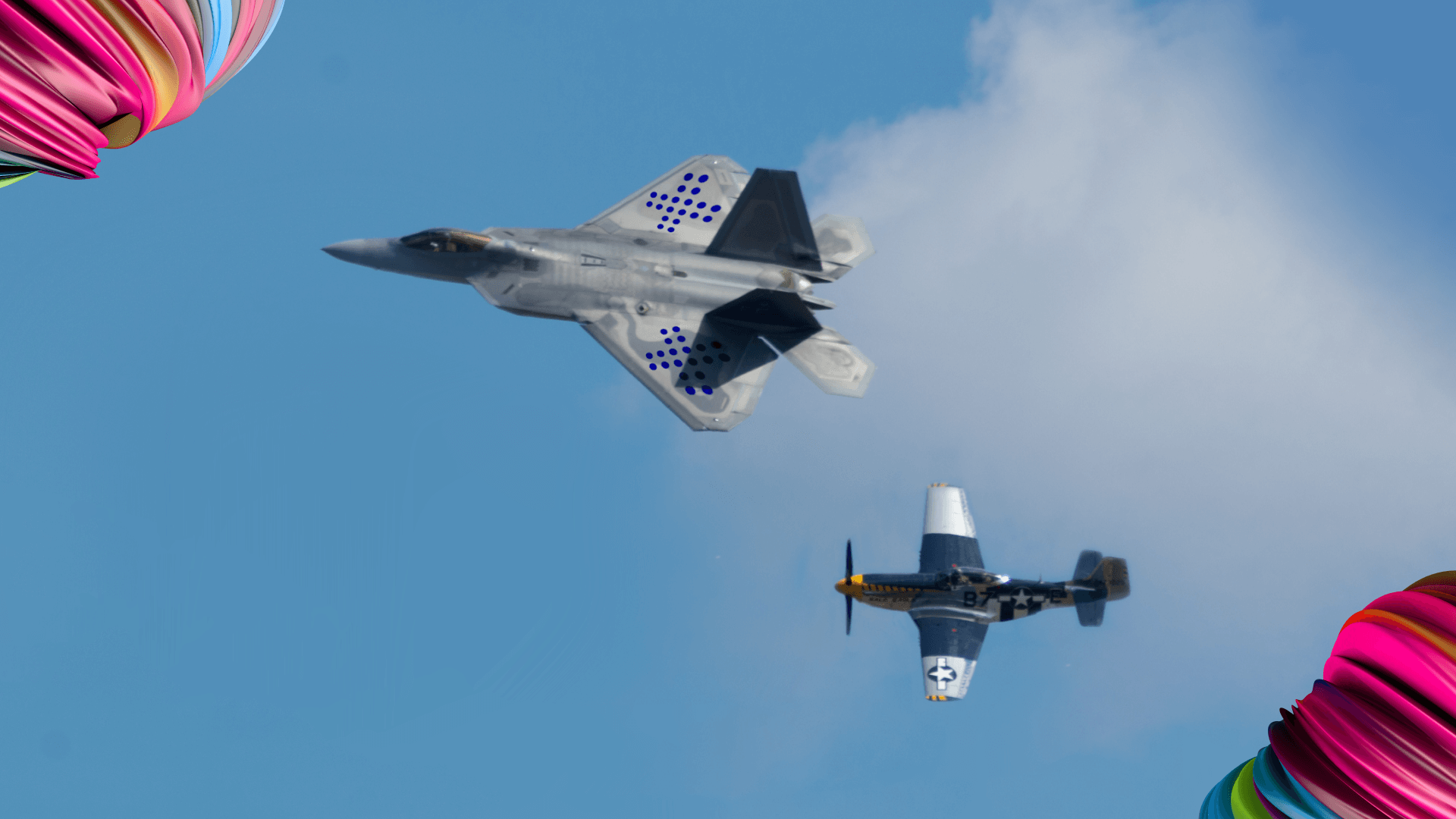 two planes flying - a fighter jet with Flextrack branding and an older model that has a hard time keeping up.