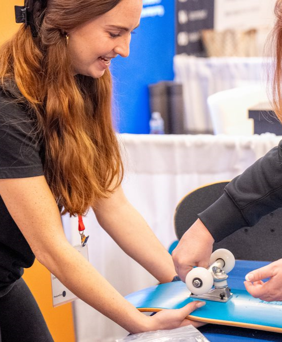 Eventgoers building custom Flextrack skateboards