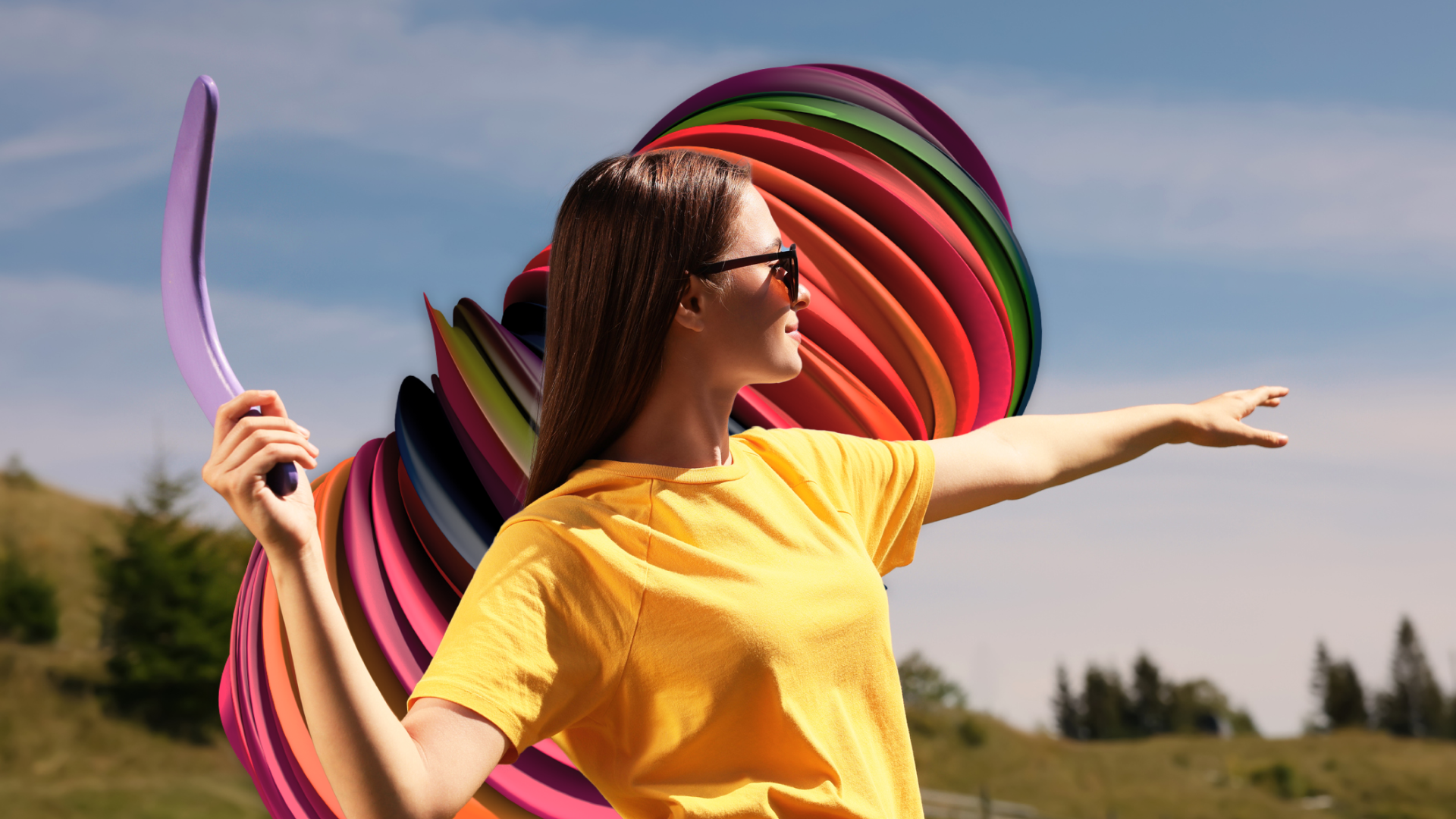 A young woman in a bright yellow shirt throws a boomerang