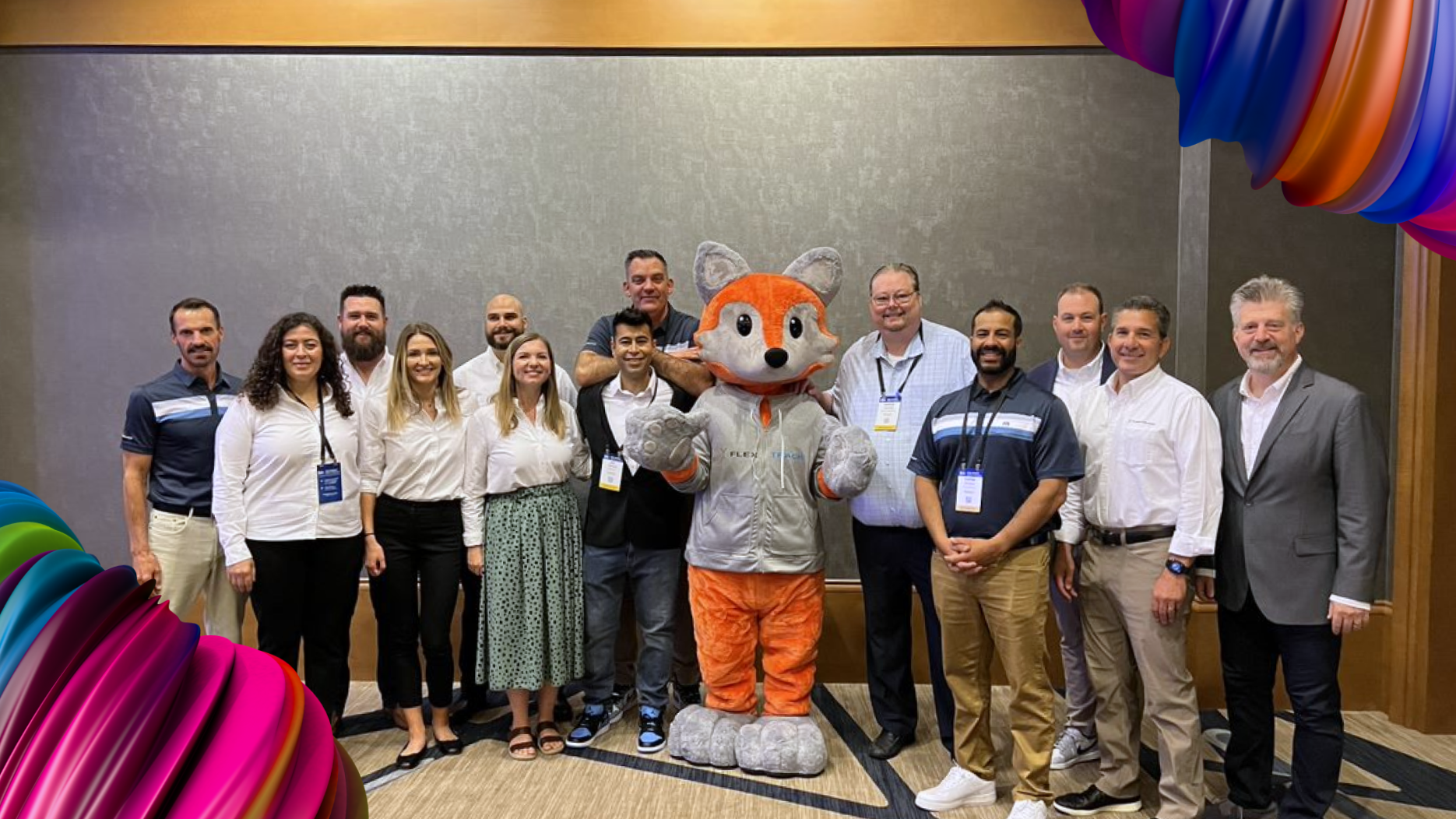 Flextrack team group photo with the Flex mascot at the CWS conference.